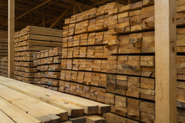 lots planks stacked top each other warehouse lumber further use construction 600x400