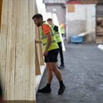 The team lifting roof trusses and floor joists onto a delivery truck